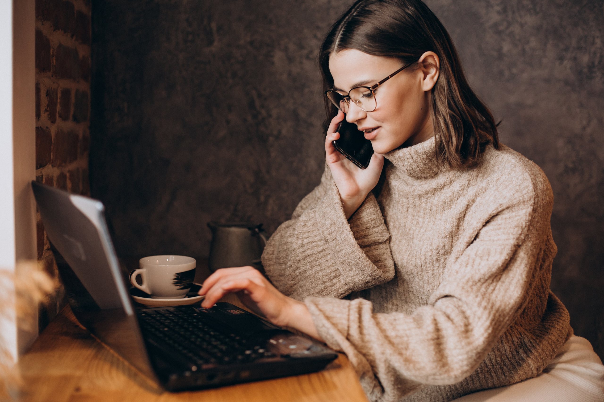 young woman behind laptop, working
